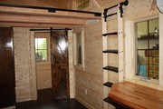 A slider door conceals the tiny bathroom, which a ladder hangs ready to climb to sleep loft.